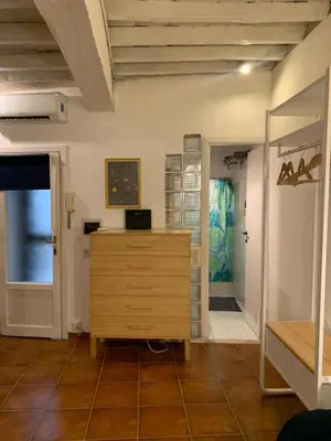 a room with a wooden dresser and a door at Ideal for your Roman Holidays in Rome