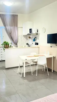 a kitchen with a table and chairs in a kitchen at Gemelli tre in Rome