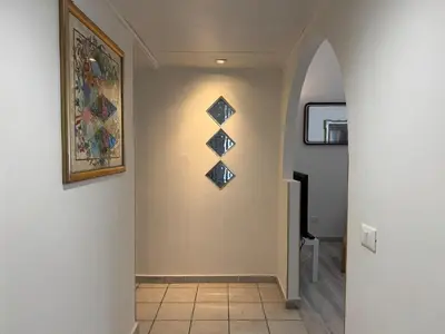a hallway with a wall with four triangles on it at Gianicolense sweet Home in Rome