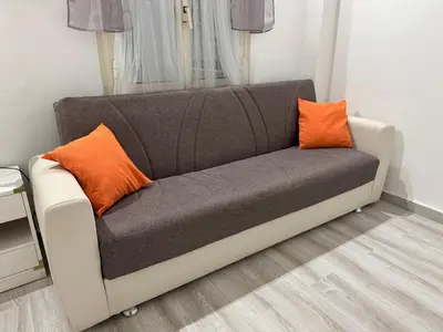a couch with two orange pillows in a room at Gianicolense sweet Home in Rome