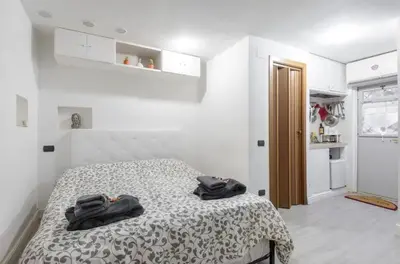 a bedroom with a bed with two black bags on it at Rome Studio Centro Storico in Rome