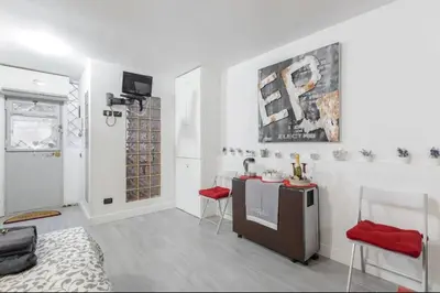 a living room with a table and red chairs at Rome Studio Centro Storico in Rome