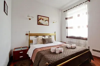 a bedroom with a bed with two towels on it at Home Relax Appia San Giovanni in Rome