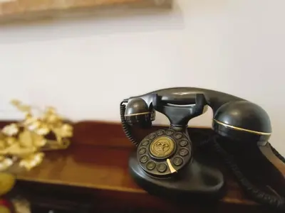 a black rotary phone sitting on a table at Home Relax Appia San Giovanni in Rome