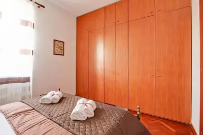 a bedroom with a bed with two white shoes on it at Home Relax Appia San Giovanni in Rome
