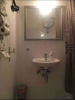 a bathroom with a sink and a mirror at Cenci Rome Centro Storico in Rome