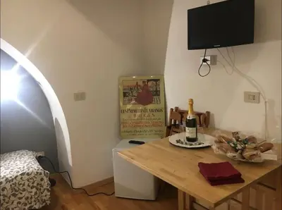 a room with a table and a tv on the wall at Cenci Rome Centro Storico in Rome