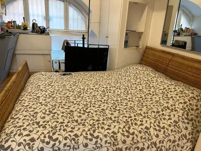 a large bed in a room with a large window at Cenci Rome Centro Storico in Rome