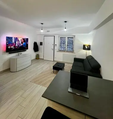 a living room with a couch and a flat screen tv at Elegant & Spacious 2BR 2BA Unit with Private Patio in Rome