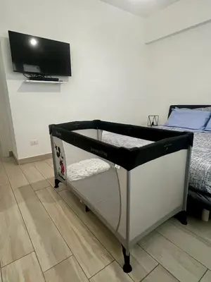 a bed in a bedroom with a tv on the wall at Elegant & Spacious 2BR 2BA Unit with Private Patio in Rome