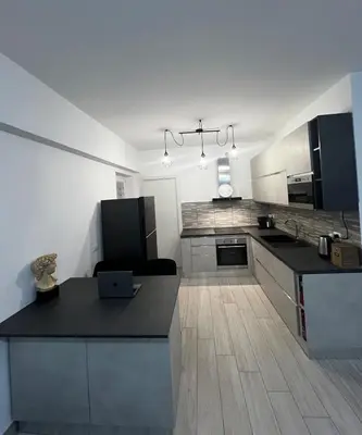 a kitchen with a laptop on top of a counter at Elegant & Spacious 2BR 2BA Unit with Private Patio in Rome