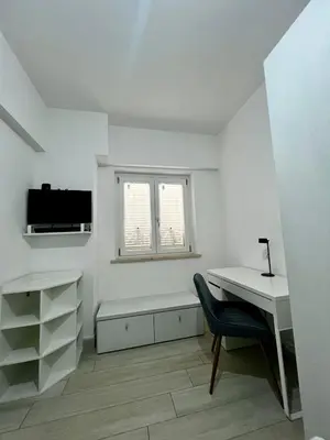 a white room with a desk and a window at Elegant & Spacious 2BR 2BA Unit with Private Patio in Rome