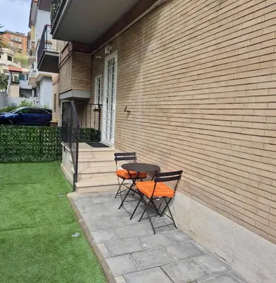 two chairs and a table in front of a house at Elegant & Spacious 2BR 2BA Unit with Private Patio in Rome