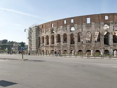 a large brick building on the side of a street at Coral flat Colosseo in Rome