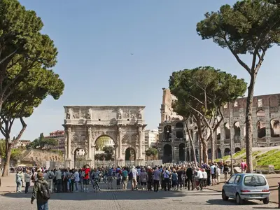 a large crowd of people standing in front of the coliseum at Coral flat Colosseo in Rome
