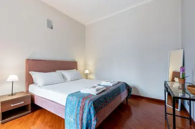 a bedroom with a bed and a table with a night stand at La Grande Casa - City Center in Rome