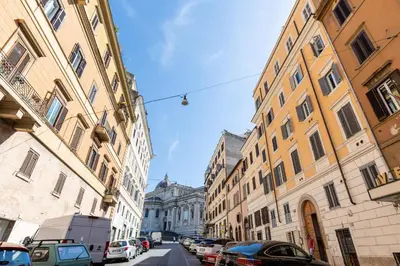 a city street with buildings and cars parked on the street at La Grande Casa - City Center in Rome