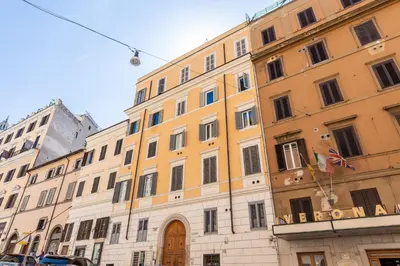 a large yellow building with a sign on it at La Grande Casa - City Center in Rome