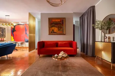 a living room with a red couch and a table at SAN GIACOMO 22 Luxury House in Rome