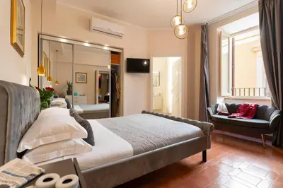 a bedroom with a bed and a living room at SAN GIACOMO 22 Luxury House in Rome