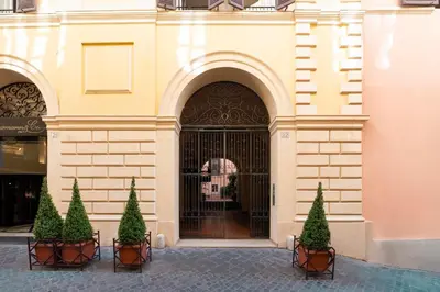 a building with a door with trees in front of it at SAN GIACOMO 22 Luxury House in Rome