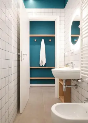 a bathroom with a white sink and a blue wall at Station To Station Rome Ensuite Rooms in Rome