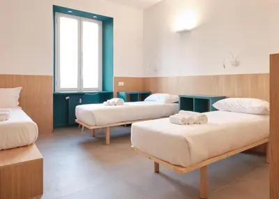 a room with three beds in a room at Station To Station Rome Ensuite Rooms in Rome