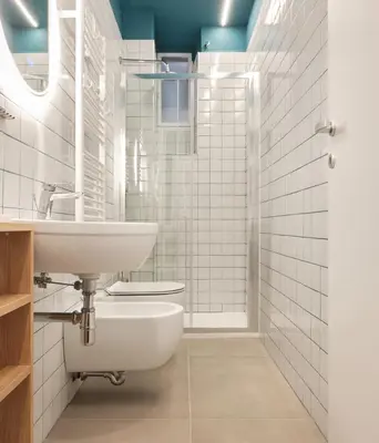 a white bathroom with a sink and a shower at Station To Station Rome Ensuite Rooms in Rome