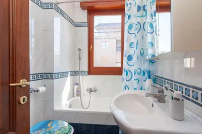 a bathroom with a sink and a shower curtain at LIVI20 Apartment Gemelli in Rome