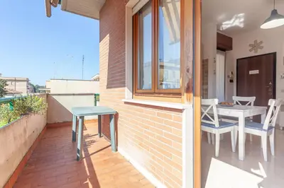 a patio with a table and chairs on a balcony at LIVI20 Apartment Gemelli in Rome