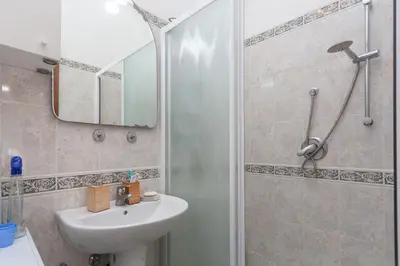 a bathroom with a sink and a shower at LIVI20 Apartment Gemelli in Rome