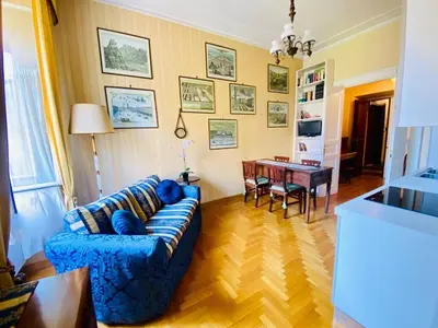 a living room with a blue couch and a table at My Varrone Suite in Rome