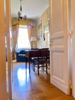a living room with a piano and a room with a couch at My Varrone Suite in Rome