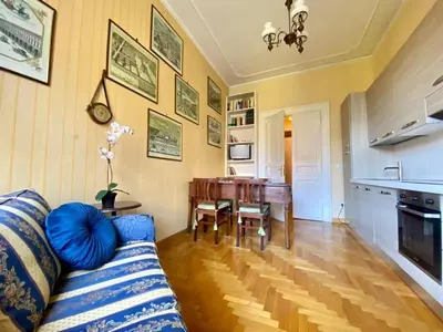 a living room with a couch and a table at My Varrone Suite in Rome