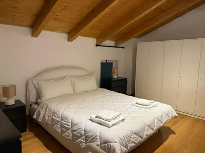 a bedroom with a bed with two towels on it at Kejsi Home in Rome