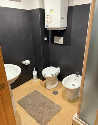 a bathroom with a toilet and a sink at Kejsi Home in Rome