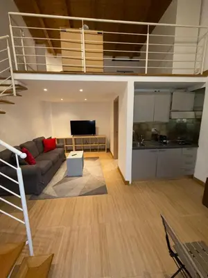 a living room with a loft bed and a kitchen at Kejsi Home in Rome