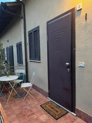 a door to a house with a table and chairs at Kejsi Home in Rome