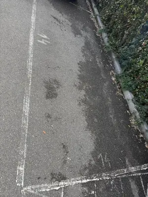 aphalt street with a bunch of stains on the road at Kejsi Home in Rome