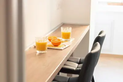 a table with two glasses of orange juice on it at Luxury & Design Apartment Piramide in Rome