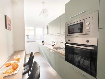a kitchen with white cabinets and a stove top oven at Luxury & Design Apartment Piramide in Rome