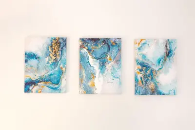 a set of three paintings of blue at Luxury & Design Apartment Piramide in Rome