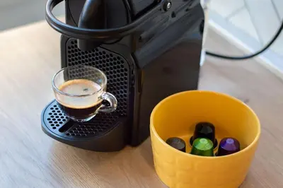 a cup of coffee sitting next to a coffee maker at Luxury & Design Apartment Piramide in Rome