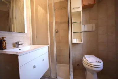 a bathroom with a shower and a toilet and a sink at San Giovanni Holiday Home in Rome