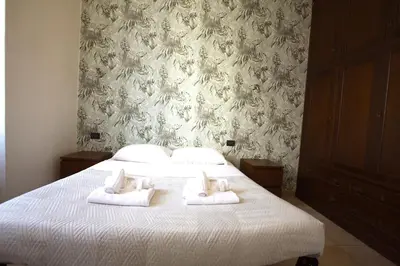a bedroom with a bed with towels on it at San Giovanni Holiday Home in Rome