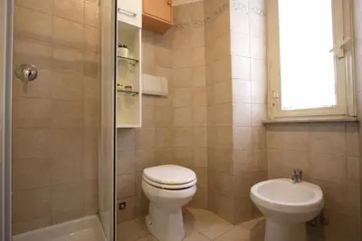 a bathroom with a toilet and a sink at San Giovanni Holiday Home in Rome