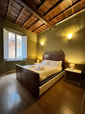 a bedroom with a large bed and a window at Artist apartment in the heart of Trastevere in Rome