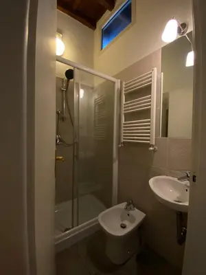 a bathroom with a shower and a toilet and a sink at Artist apartment in the heart of Trastevere in Rome