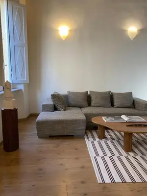 a living room with a couch and a coffee table at Artist apartment in the heart of Trastevere in Rome