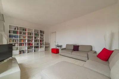 a living room with two couches and book shelves at GuestHost - Trastevere Station Bright Apartment with Terrace in Rome